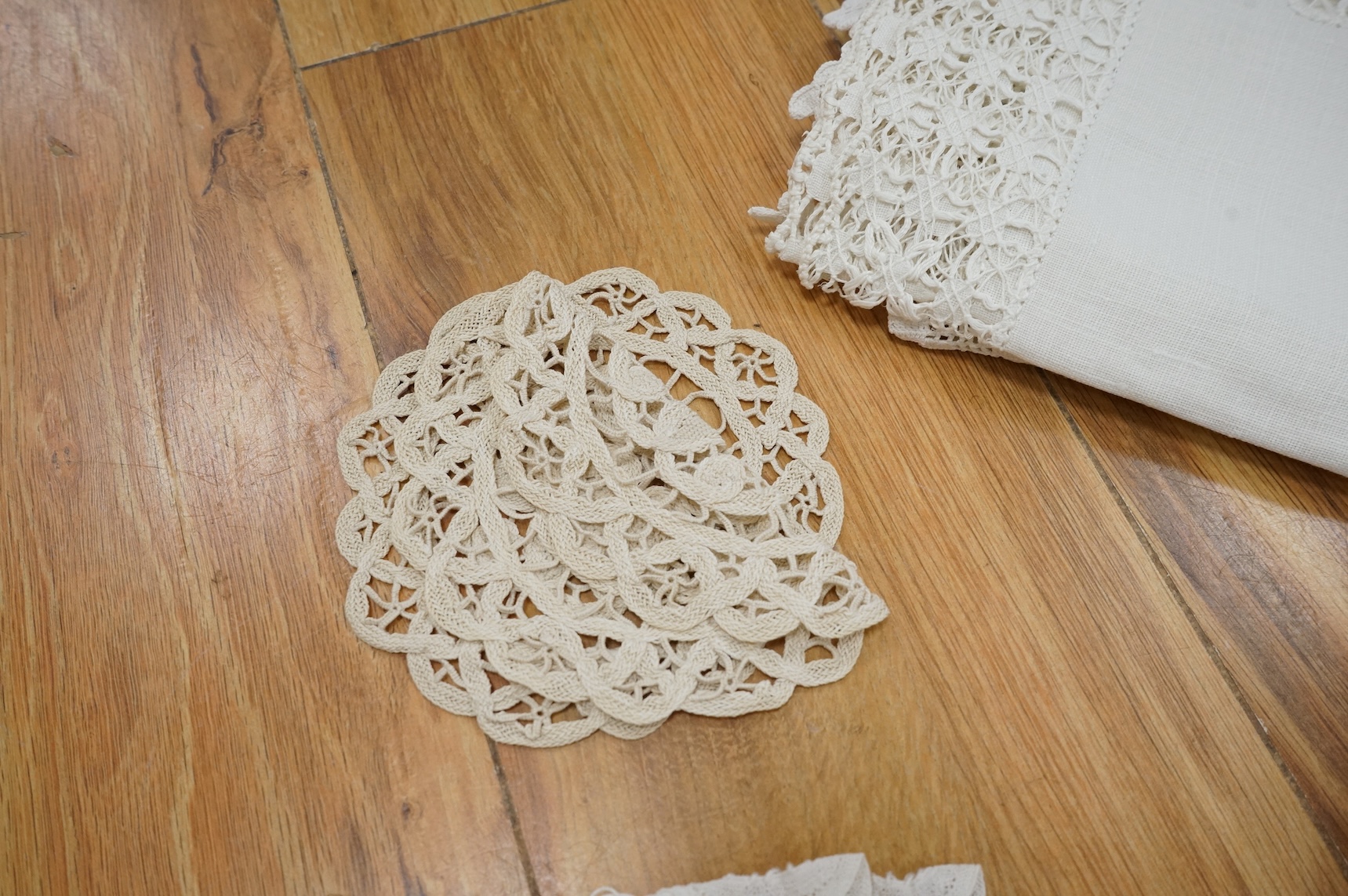 A collection of early 20th century and later crochet, cut work and drawn thread table linens and a large embroidered table cloth